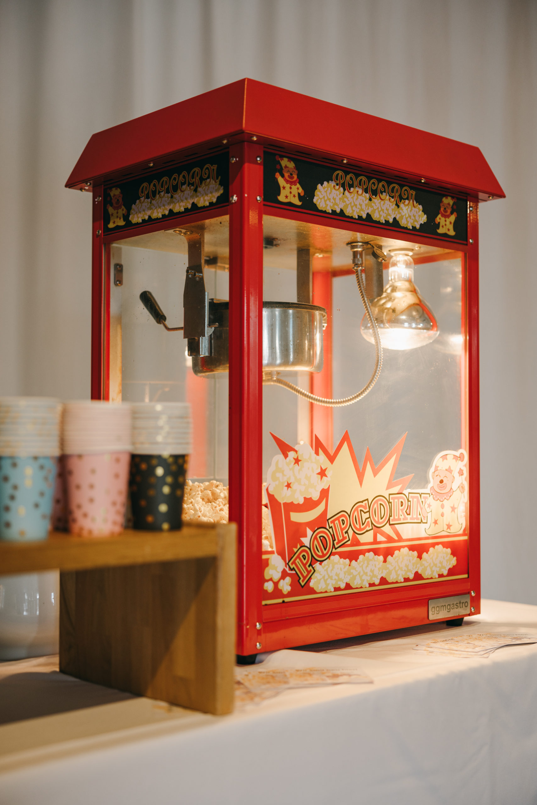Rote Popcornmaschine mit bunten Bechern